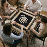 Black mahjong mat with gold dragon artwork, a scalloped edge, and printed Mahjong rules on the surface.