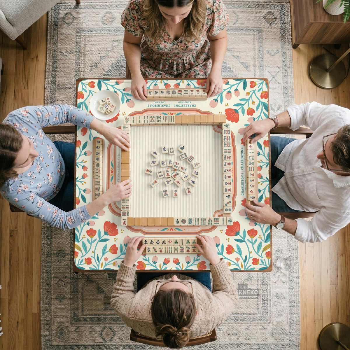 Cream mahjong mat with a coral and teal floral border, rule layout text, Charleston guide notes, and a blank center area for tile play.