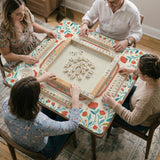 Cream mahjong mat with a coral and teal floral border, rule layout text, Charleston guide notes, and a blank center area for tile play.