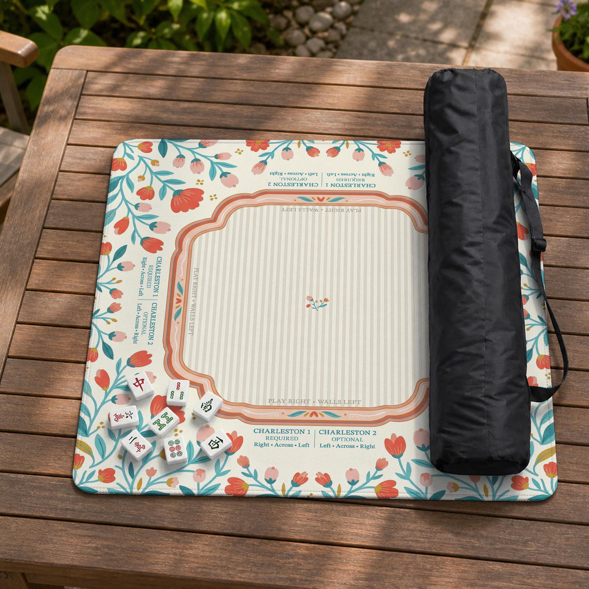 Cream mahjong mat with a coral and teal floral border, rule layout text, Charleston guide notes, and a blank center area for tile play.