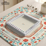 Cream mahjong mat with a coral and teal floral border, rule layout text, Charleston guide notes, and a blank center area for tile play.