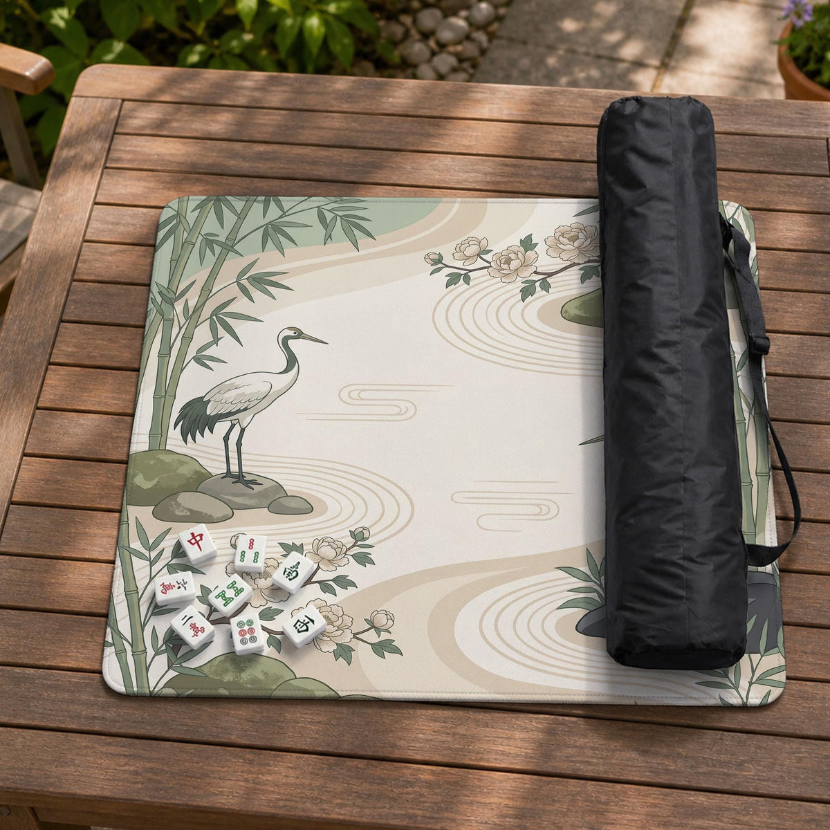 Square mahjong mat with a cream background, sage green cranes, bamboo leaves, peony branches, stones, and thin linework.