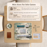 Square mahjong mat with a cream background, sage green cranes, bamboo leaves, peony branches, stones, and thin linework.
