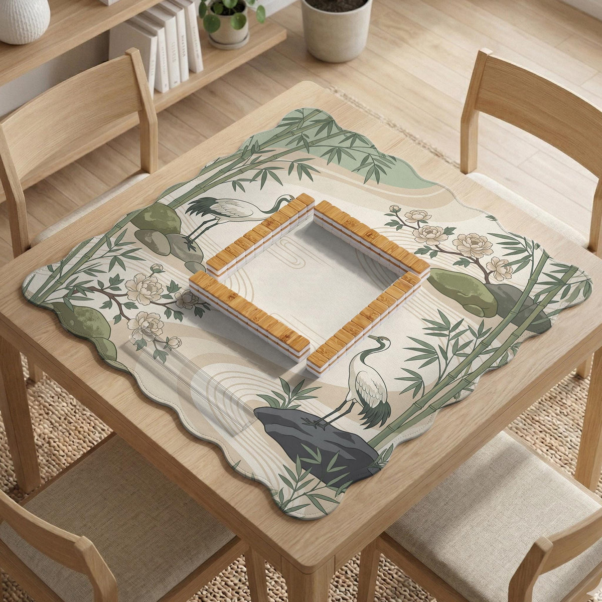 Square mahjong mat with a cream background, sage green cranes, bamboo leaves, peony branches, stones, and thin linework.