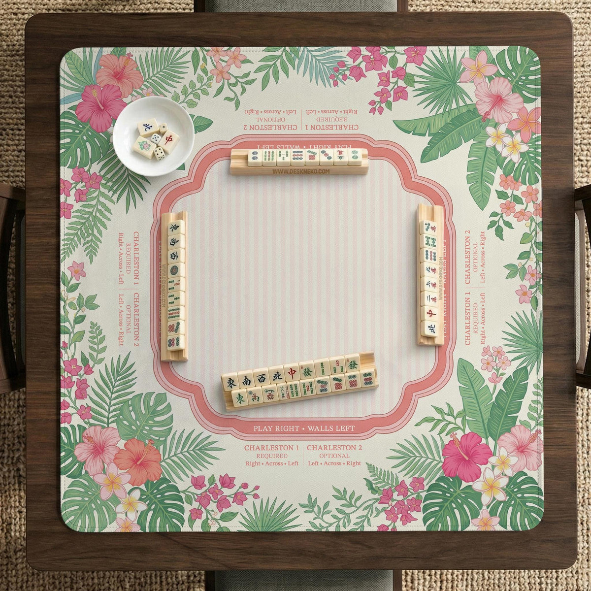Coral tropical floral mahjong mat with hibiscus flowers, palm leaves, cream sections, and a scalloped edge.