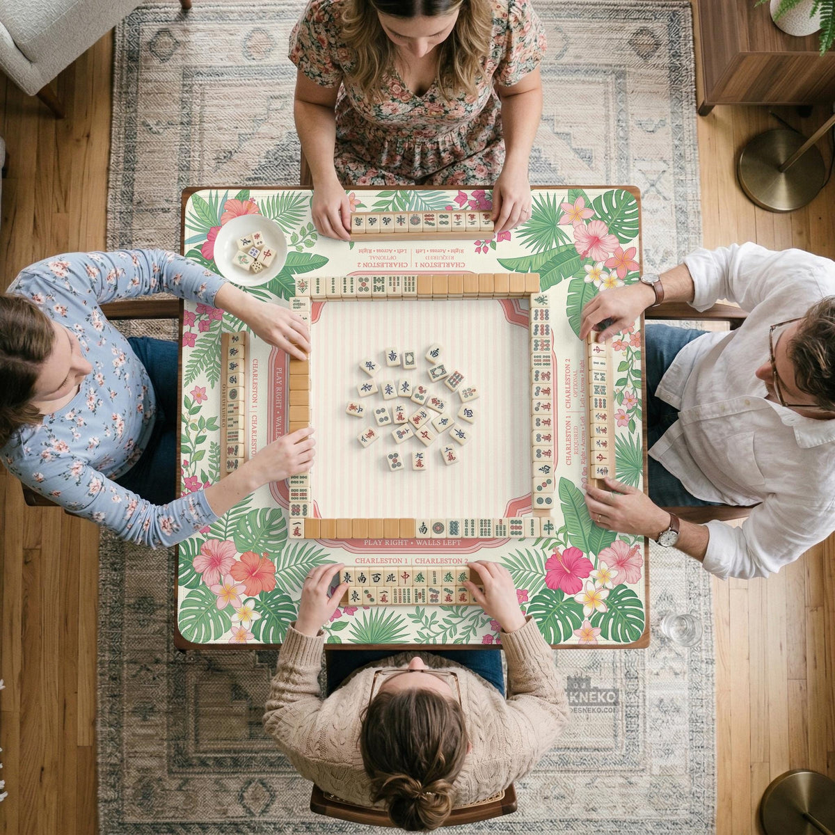Coral tropical floral mahjong mat with hibiscus flowers, palm leaves, cream sections, and a scalloped edge.