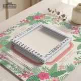 Coral tropical floral mahjong mat with hibiscus flowers, palm leaves, cream sections, and a scalloped edge.