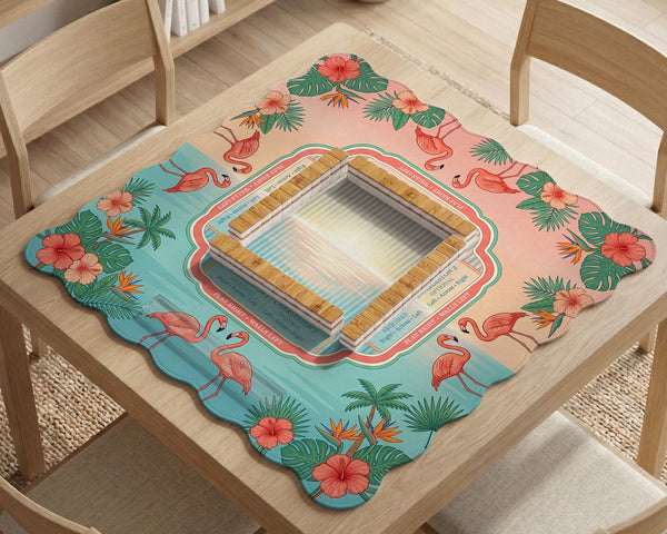 A square mahjong mat with flamingos, hibiscus flowers, palm leaves, and aqua water accents on a coral background with a scalloped edge.