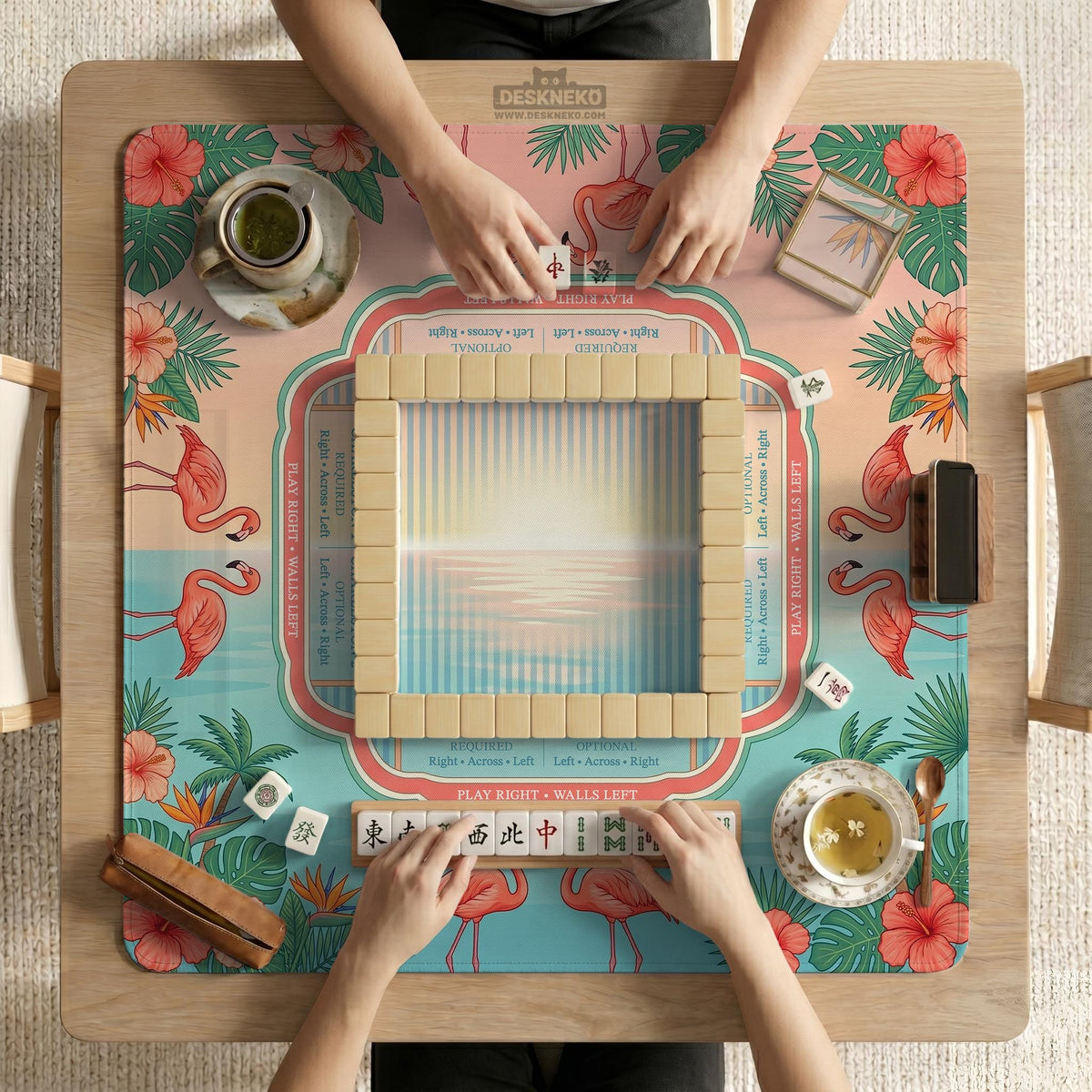 Pink mahjong mat with flamingos, palm leaves, hibiscus flowers, and aqua tropical background.