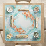 A soft blue mahjong mat with koi fish, floating lily pads, pale floral details, and a watercolor-style pond design.