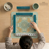 Sage green square mahjong mat with lotus flowers, golden dragons, and an ornamental center design.