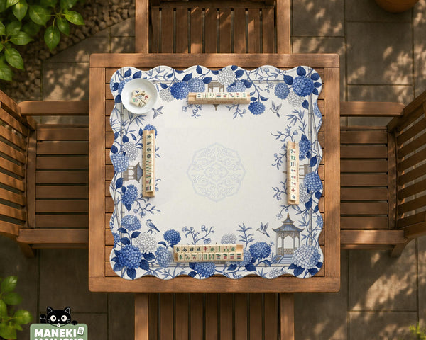 Blue and white square mahjong mat with a hydrangea and bird botanical border and a plain center area.
