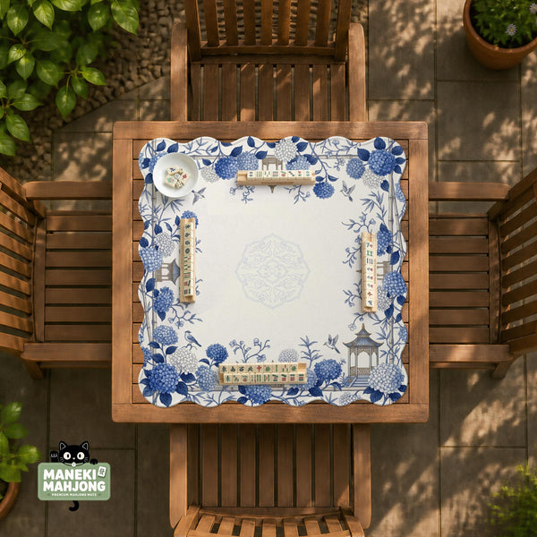 Blue and white square mahjong mat with a hydrangea and bird botanical border and a plain center area.