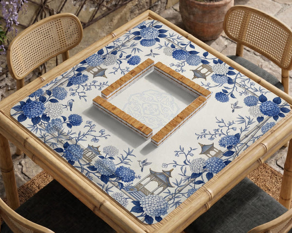 Blue and white square mahjong mat with a hydrangea and bird botanical border and a plain center area.