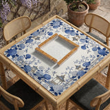 Blue and white square mahjong mat with a hydrangea and bird botanical border and a plain center area.