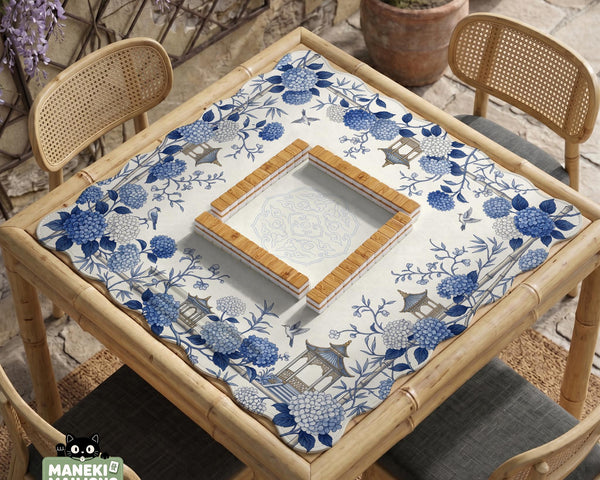 Blue and white square mahjong mat with a hydrangea and bird botanical border and a plain center area.