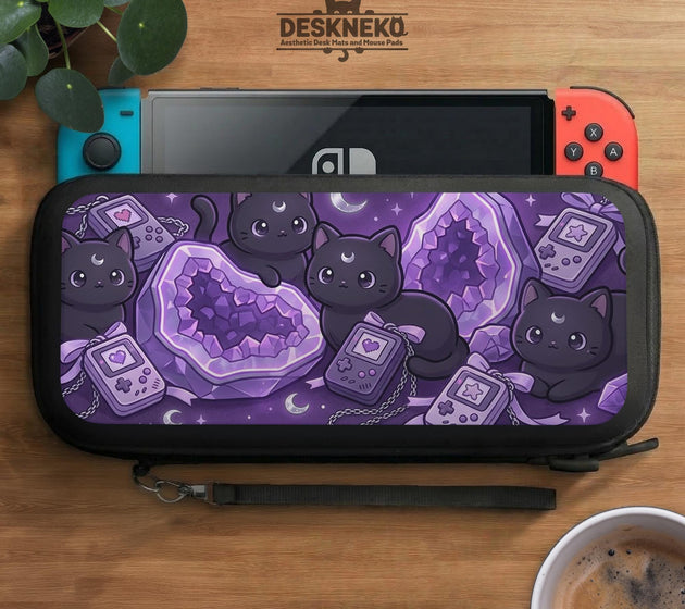 Purple carrying case with black cat faces, moon shapes, stars, and crystal geode style artwork for Nintendo Switch.
