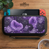 Purple carrying case with black cat faces, moon shapes, stars, and crystal geode style artwork for Nintendo Switch.