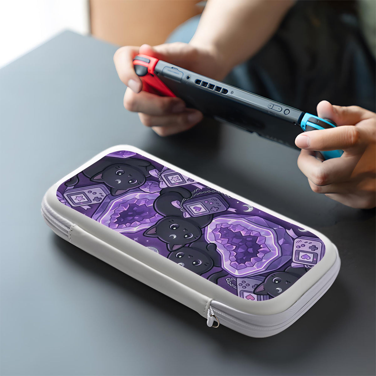 Purple carrying case with black cat faces, moon shapes, stars, and crystal geode style artwork for Nintendo Switch.