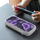 Purple carrying case with black cat faces, moon shapes, stars, and crystal geode style artwork for Nintendo Switch.