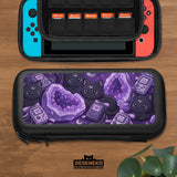 Purple carrying case with black cat faces, moon shapes, stars, and crystal geode style artwork for Nintendo Switch.