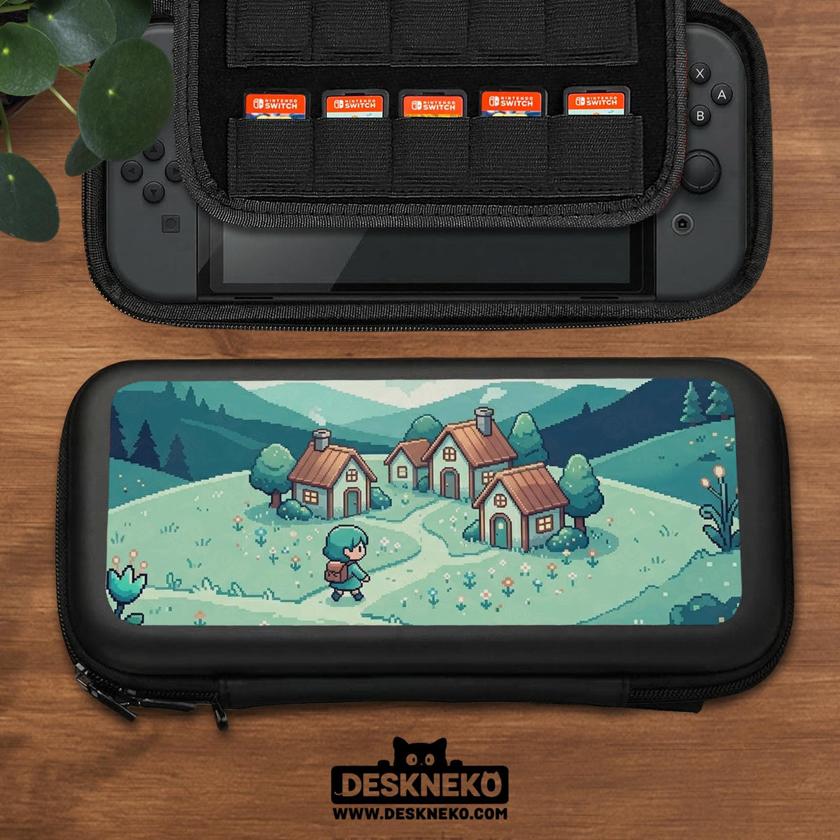 Teal carrying case with a pixel-style village scene, small houses, layered mountains, flowers, and a retro game-inspired landscape design.