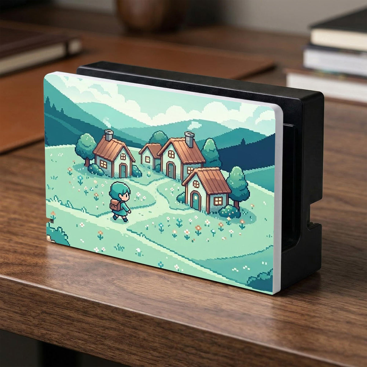 Teal carrying case with a pixel-style village scene, small houses, layered mountains, flowers, and a retro game-inspired landscape design.