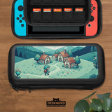 Teal carrying case with a pixel-style village scene, small houses, layered mountains, flowers, and a retro game-inspired landscape design.