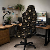 Black chair cover with a moth, moon, and flower pattern in gold, ivory, and dark botanical tones.
