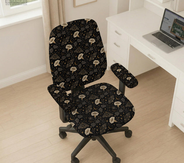 Black chair cover with a moth, moon, and flower pattern in gold, ivory, and dark botanical tones.