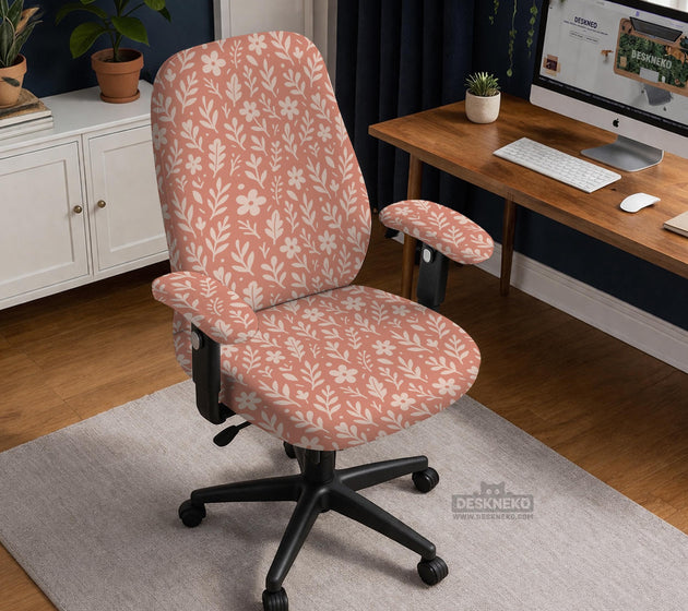 Pink chair cover with a botanical floral print shown on an office chair, with matching armrest covers and multiple cover style options.