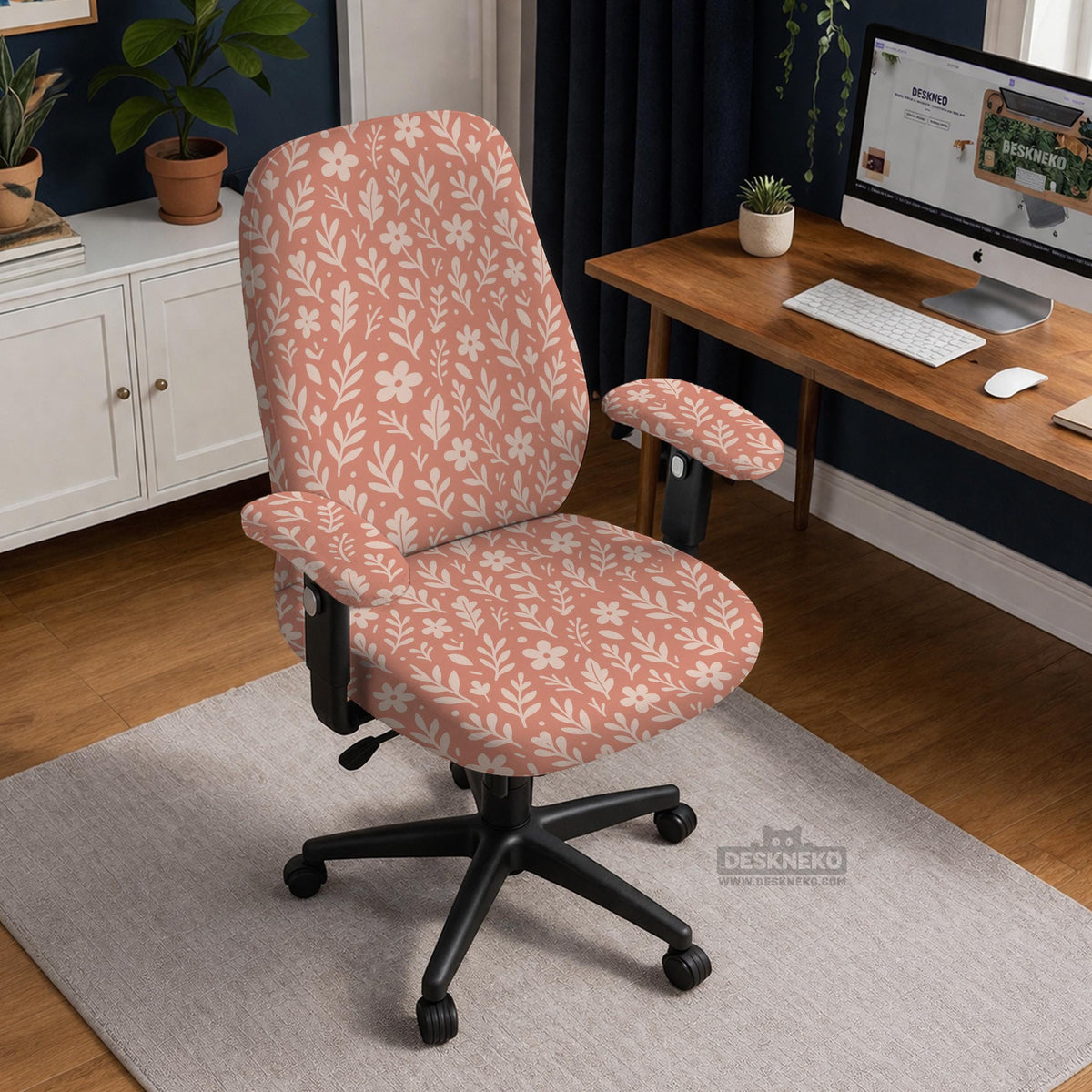 Pink chair cover with a botanical floral print shown on an office chair, with matching armrest covers and multiple cover style options.