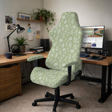 Green chair cover with a small botanical floral print in sage and cream.