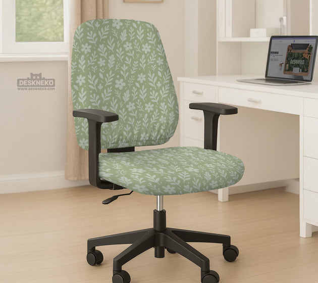 Green chair cover with a small botanical floral print in sage and cream.