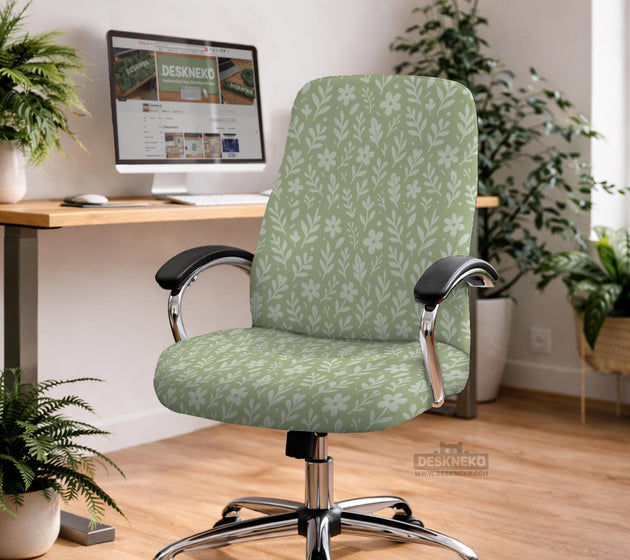 Green chair cover with a small botanical floral print in sage and cream.