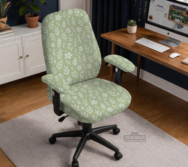 Green chair cover with a small botanical floral print in sage and cream.
