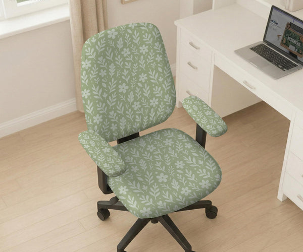 Sage green desk chair cover with a small floral and leaf print shown on an office chair.