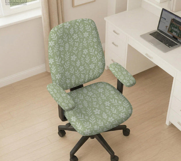 Sage green desk chair cover with a small floral and leaf print shown on an office chair.