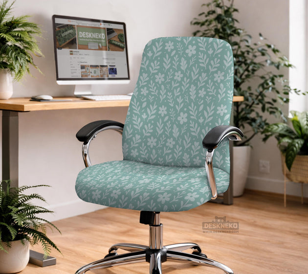 Mint and white botanical desk chair cover with a floral leaf pattern shown on an office chair.