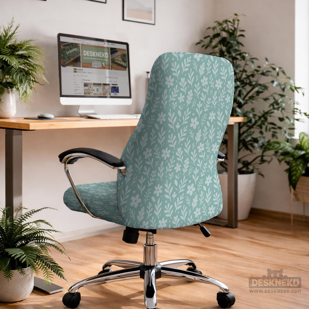 Mint and white botanical desk chair cover with a floral leaf pattern shown on an office chair.
