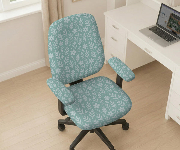 Sage and aqua green floral chair cover shown on a gaming chair with matching armrest covers.