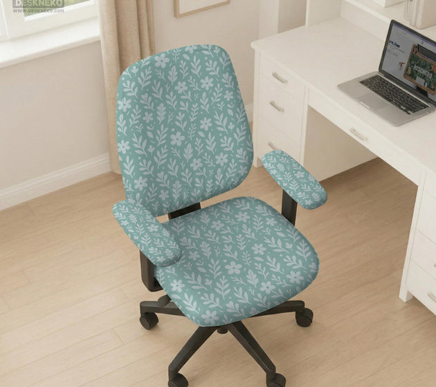 Sage and aqua green floral chair cover shown on a gaming chair with matching armrest covers.