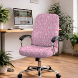 Blush pink chair cover with a small botanical floral pattern shown on an office chair.