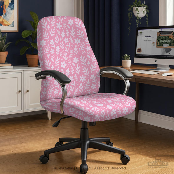 Soft pink floral chair cover shown on a gaming chair with a high back and armrests.