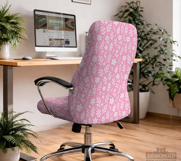 Blush pink chair cover with a small botanical floral pattern shown on an office chair.