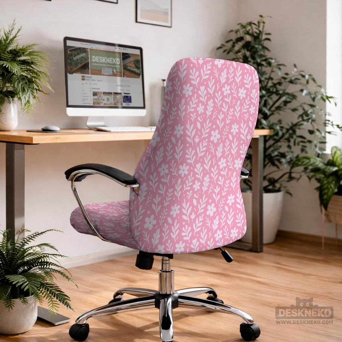 Blush pink chair cover with a small botanical floral pattern shown on an office chair.