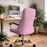 Blush pink chair cover with a small botanical floral pattern shown on an office chair.