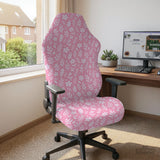 Soft pink floral chair cover shown on a gaming chair with a high back and armrests.