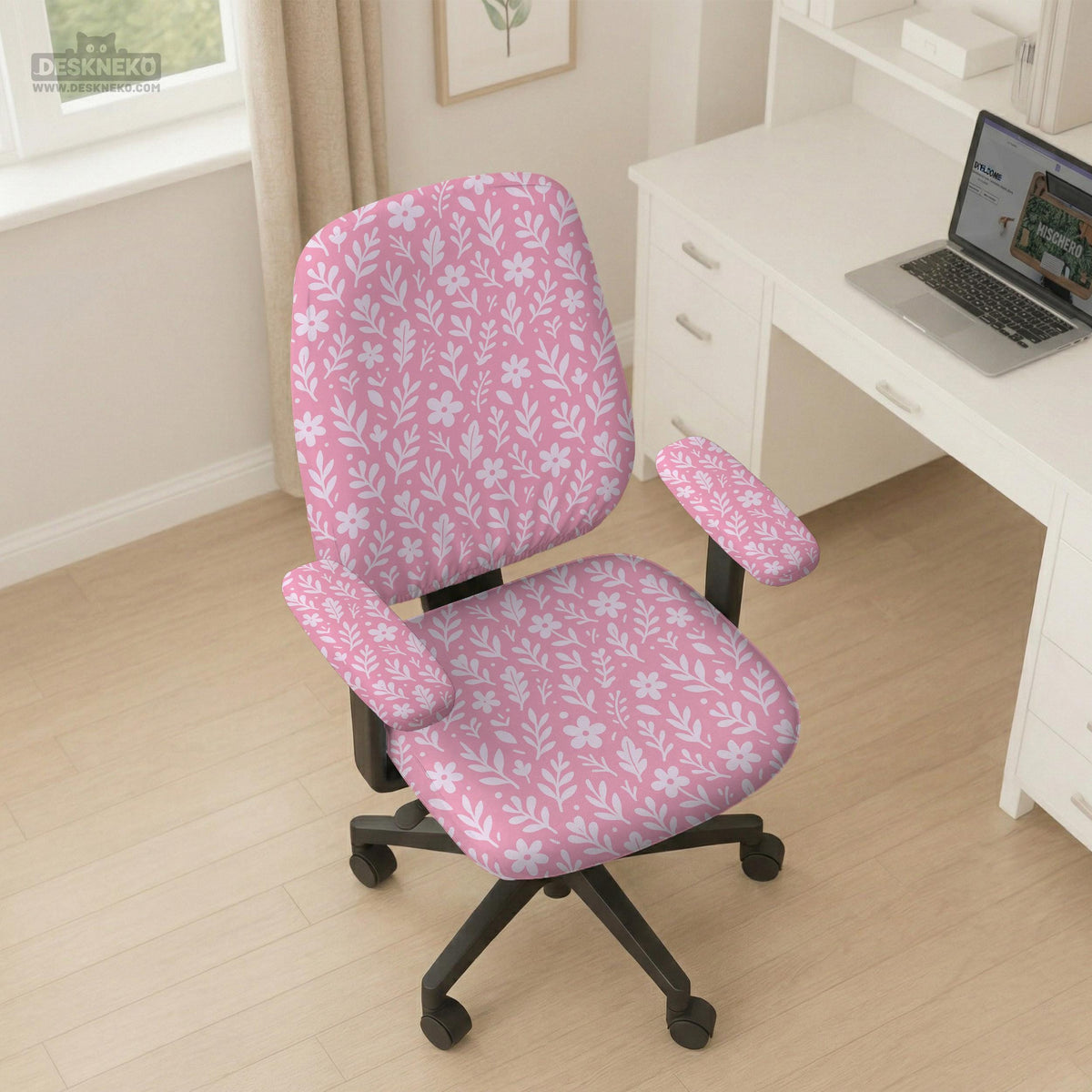 Blush pink chair cover with a small botanical floral pattern shown on an office chair.