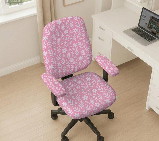 Soft pink floral chair cover shown on a gaming chair with a high back and armrests.